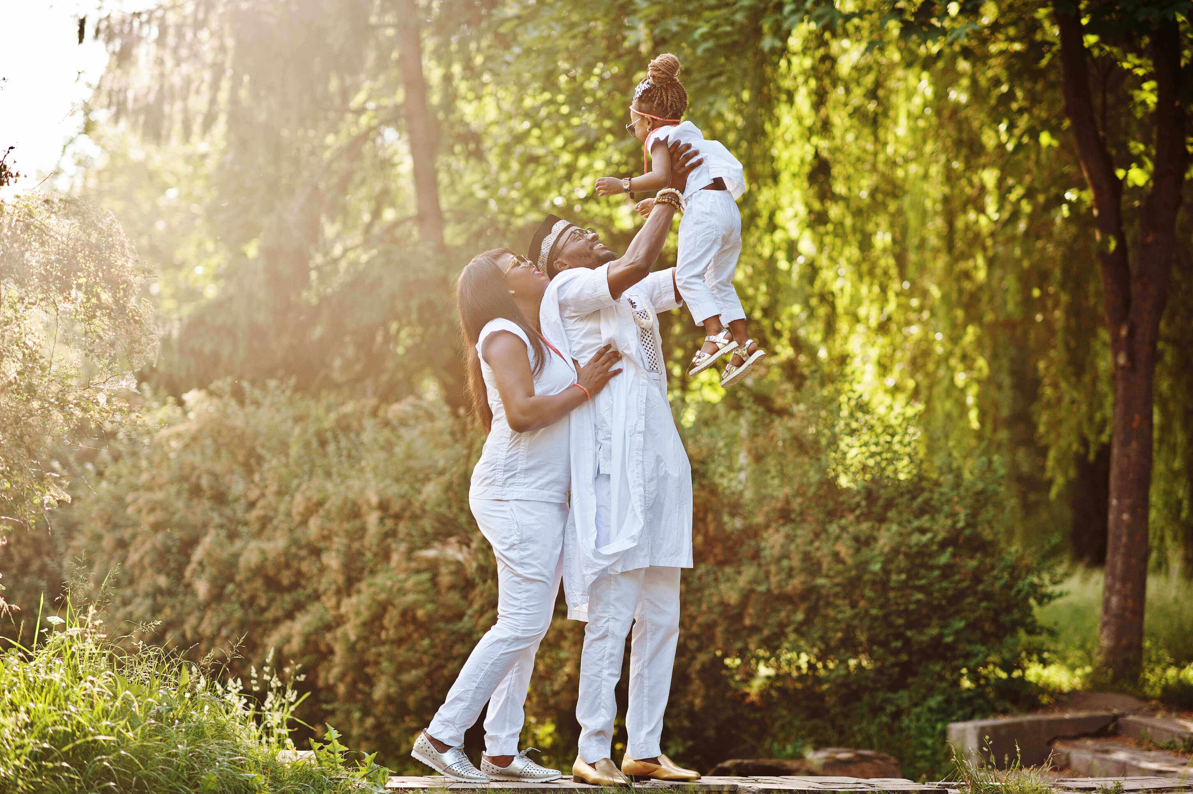 A family sitting together in warm outdoor light.